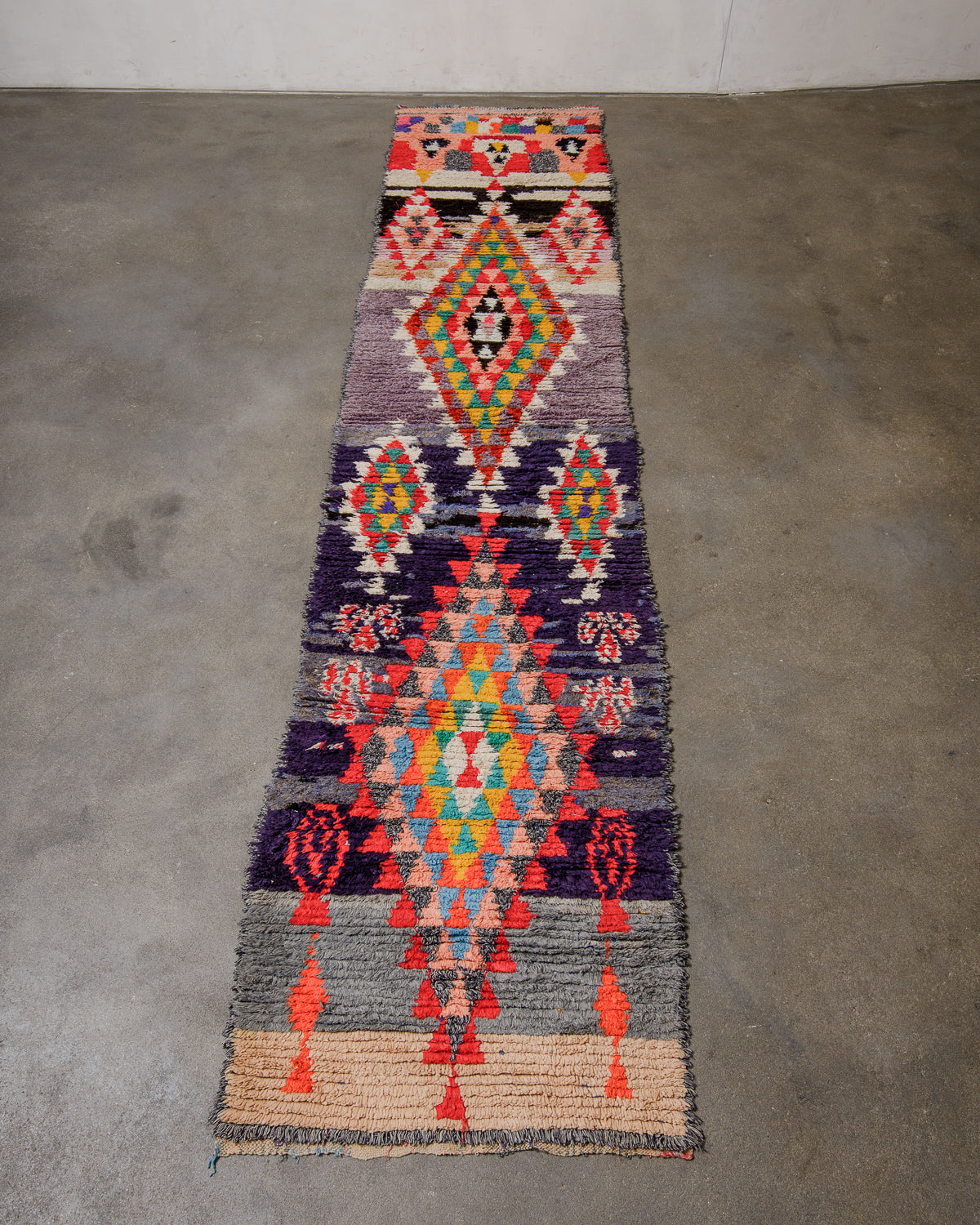 Colourful patterned rug on a concrete floor